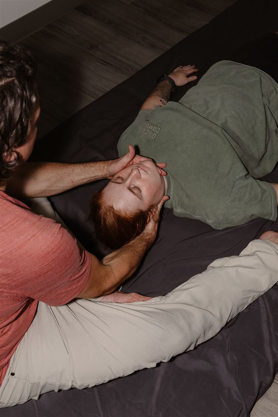 Clayton Davis performing a gentle head and neck release on a client