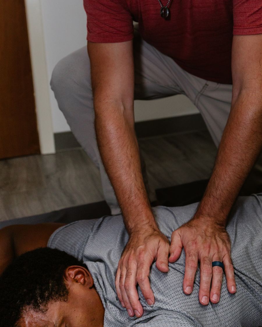 Clayton Davis performing therapeutic massage on a client's back at Spa City Stretch in Hot Springs